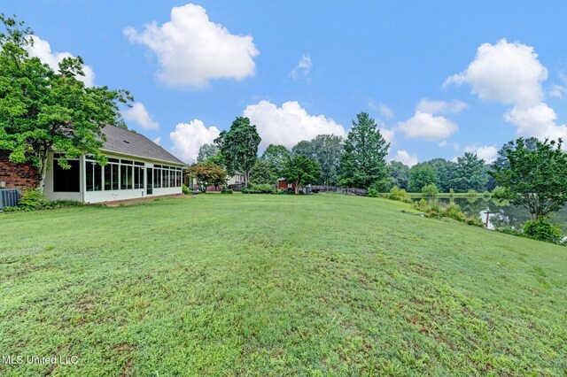 8140 Hunters Hill Cv, Olive Branch, MS 38654 - view of green lawn with a sunroom and central air condition unit