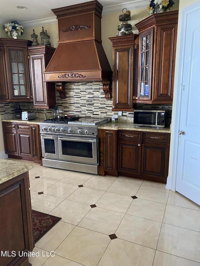 kitchen with premium range hood, backsplash, appliances with stainless steel finishes, and ornamental molding
