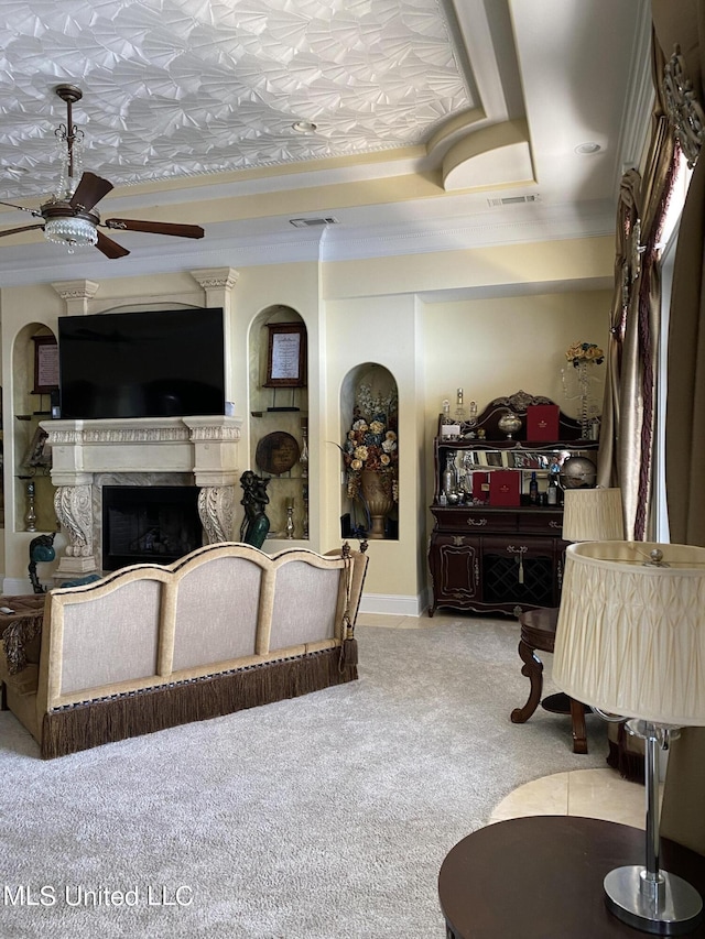 carpeted living area with visible vents, a fireplace, and ceiling fan