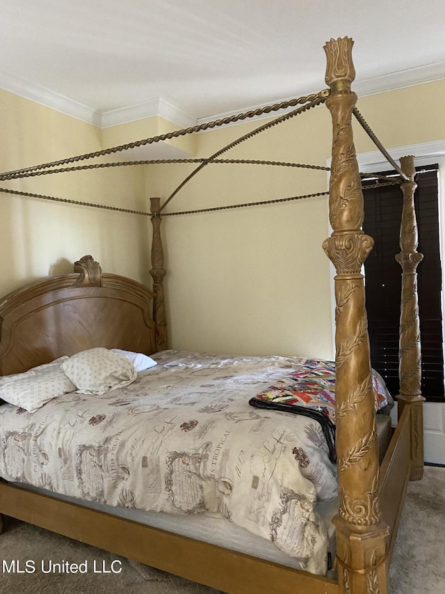 carpeted bedroom with ornamental molding