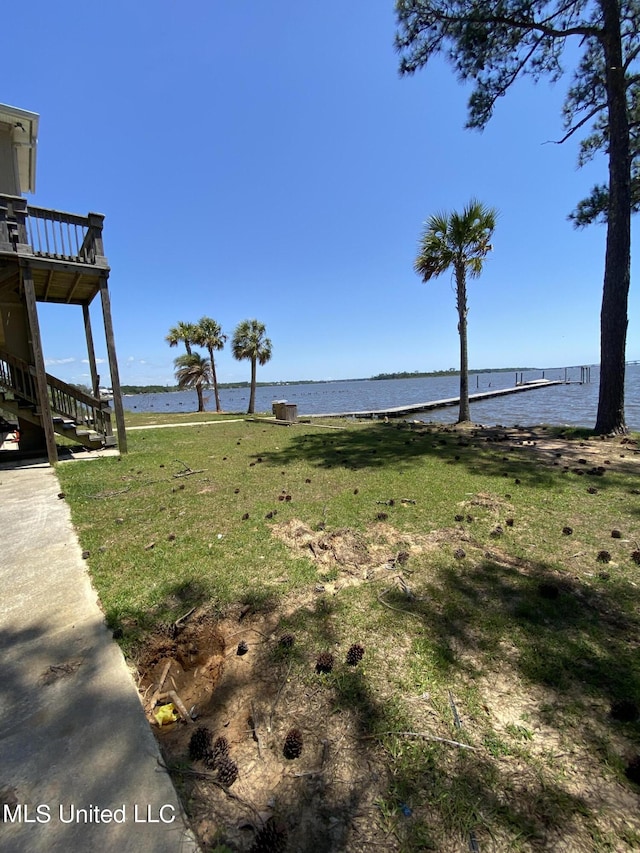 view of yard with a deck with water view