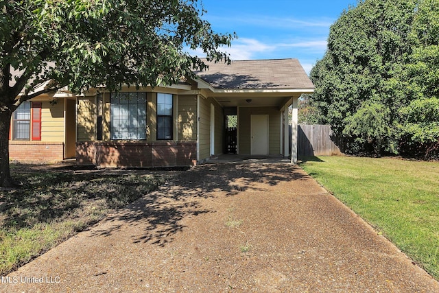 bungalow-style house featuring a front yard and a carport