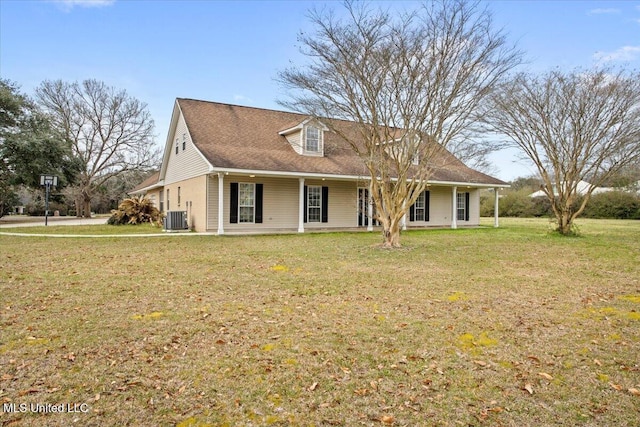 view of front facade with cooling unit and a front yard