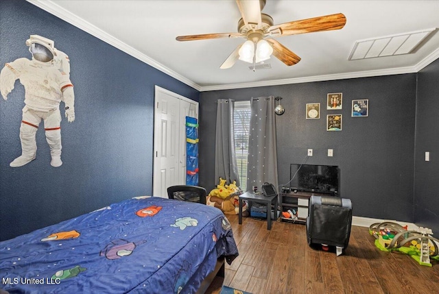 bedroom with crown molding, visible vents, a ceiling fan, wood finished floors, and baseboards