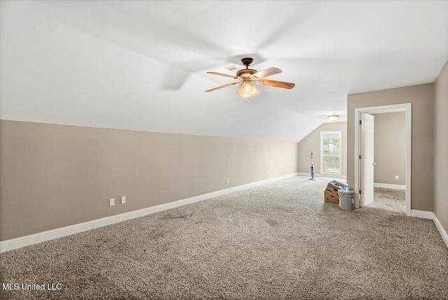 bonus room with carpet floors, vaulted ceiling, baseboards, and a ceiling fan