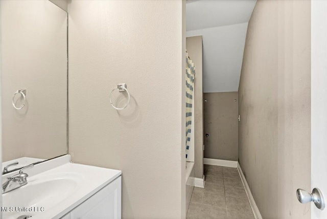 bathroom featuring vanity, baseboards, and tile patterned floors