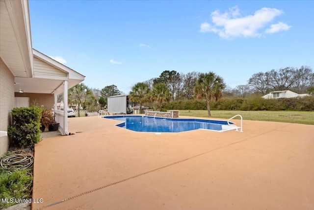 pool with an outbuilding and a patio