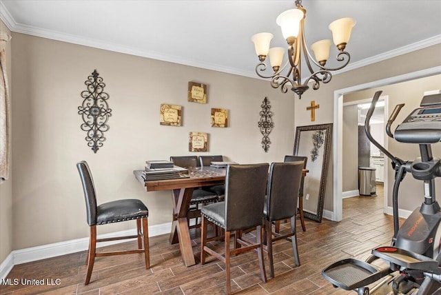 dining room featuring ornamental molding, wood tiled floor, a notable chandelier, and baseboards