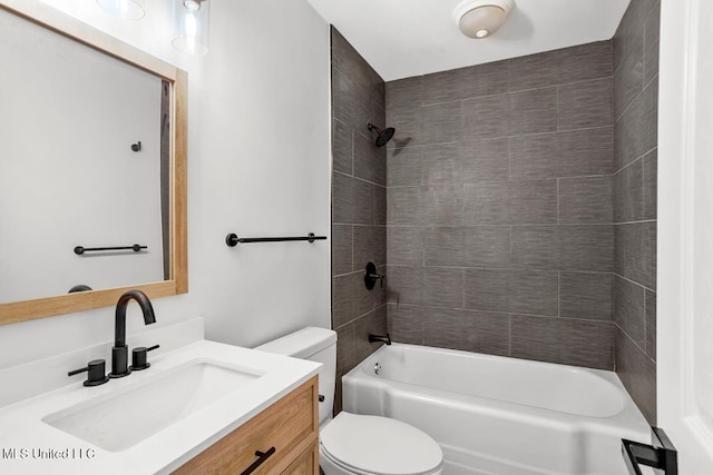 full bathroom with vanity, toilet, and tiled shower / bath