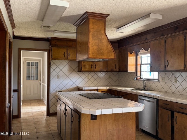 kitchen featuring decorative backsplash, tile countertops, stainless steel dishwasher, sink, and a center island