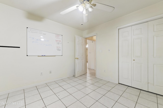 1317 Rosemont Dr, Gautier, MS 39553 - unfurnished bedroom featuring a closet, baseboards, a ceiling fan, and light tile patterned floors