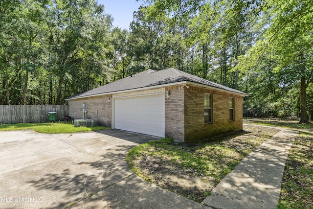 1317 Rosemont Dr, Gautier, MS 39553 - view of property exterior featuring brick siding, fence, driveway, and a garage