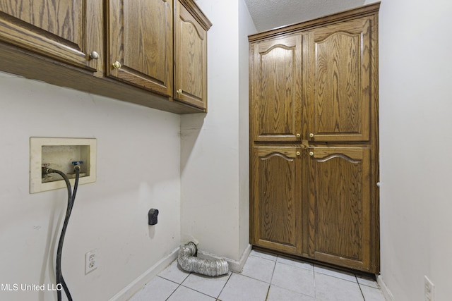 1317 Rosemont Dr, Gautier, MS 39553 - laundry room with cabinet space, baseboards, light tile patterned floors, hookup for a washing machine, and a textured ceiling