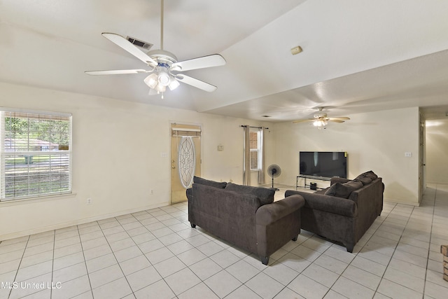 1317 Rosemont Dr, Gautier, MS 39553 - living area with ceiling fan, light tile patterned flooring, vaulted ceiling, and baseboards