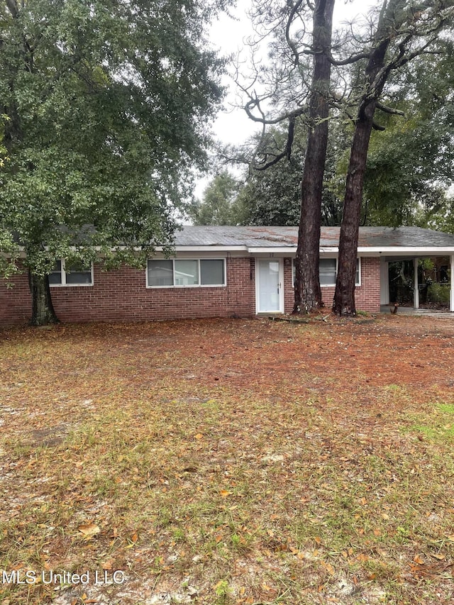 ranch-style home featuring a carport