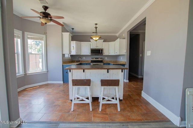 1453 Whitetail Dr, Hernando, MS 38632 - kitchen with stainless steel appliances, crown molding, a ceiling fan, wood counters, and white cabinetry