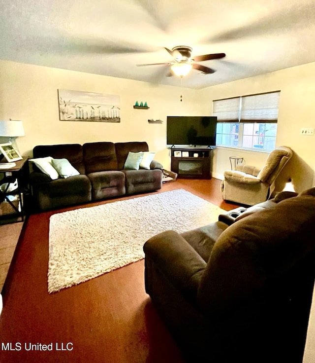 living area featuring a ceiling fan