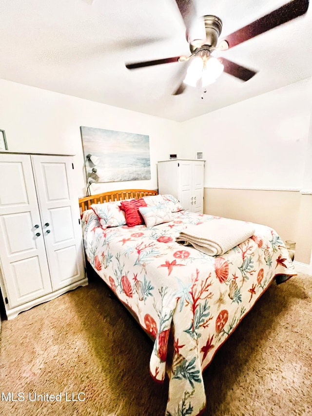 bedroom with ceiling fan, a closet, and carpet flooring