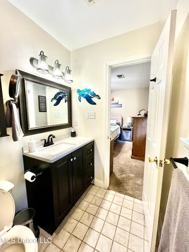 bathroom featuring baseboards, visible vents, ensuite bathroom, tile patterned flooring, and vanity