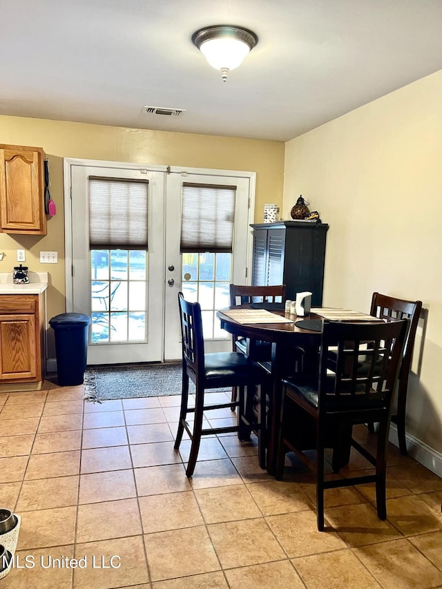 dining area with visible vents, baseboards, and light tile patterned flooring