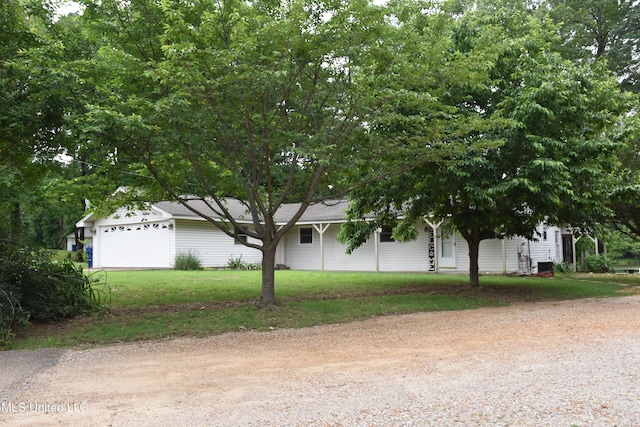10991 High Rd, Hernando, MS 38632 - view of front of house with dirt driveway, a garage, and a front lawn