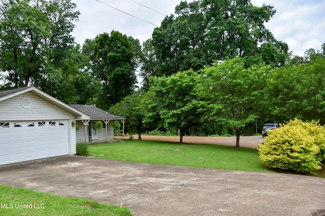 10991 High Rd, Hernando, MS 38632 - view of grassy yard featuring driveway and a garage