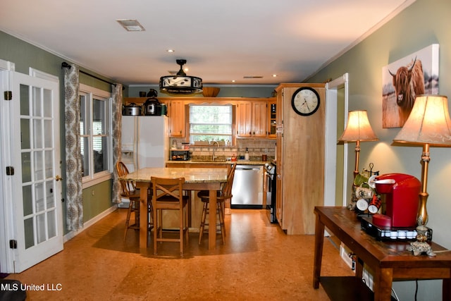 10991 High Rd, Hernando, MS 38632 - kitchen with dishwasher, a kitchen island, backsplash, ornamental molding, and light stone counters