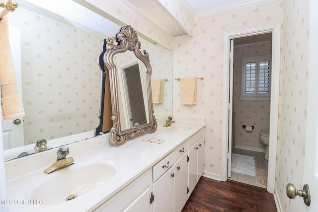 697 Country Place Dr, Pearl, MS 39208 - full bathroom with double vanity, wood finished floors, toilet, ornamental molding, and wallpapered walls