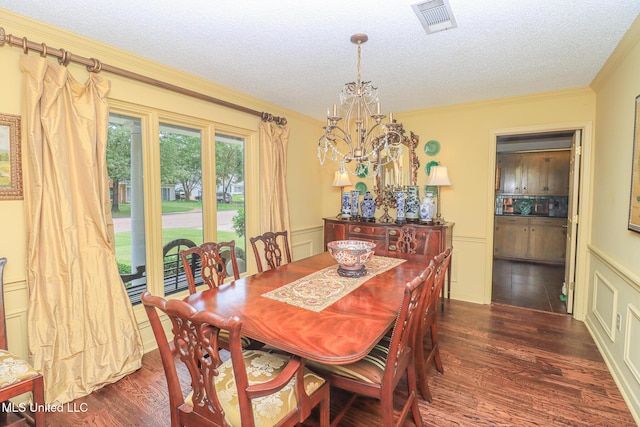 697 Country Place Dr, Pearl, MS 39208 - dining space with dark wood finished floors, crown molding, a textured ceiling, and a chandelier