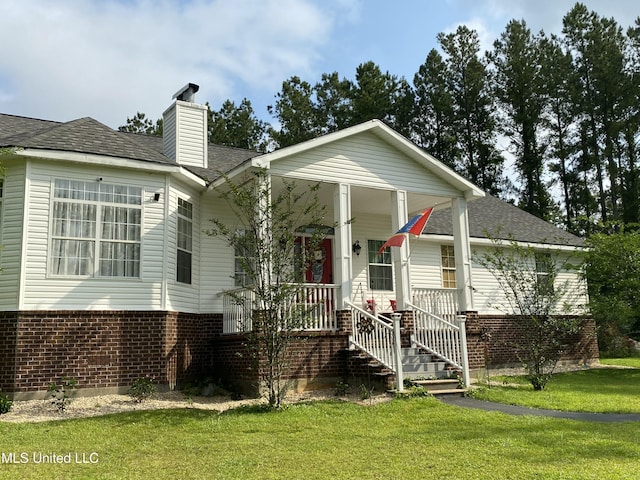 20507 Old Biloxi Rd, Vancleave, MS 39565 - view of front of home with brick siding, a front yard, covered porch, and a chimney