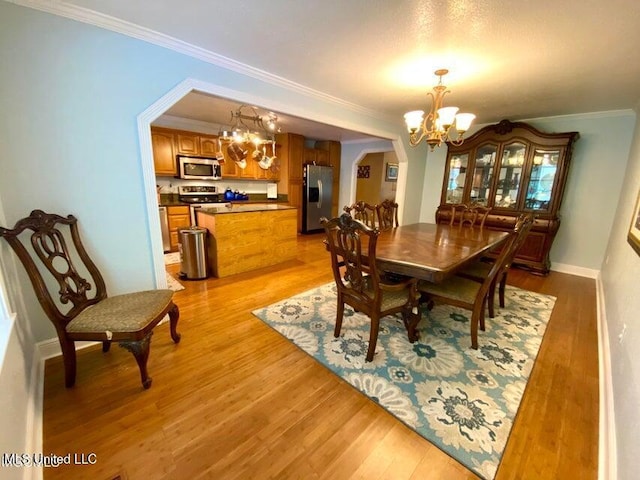 20507 Old Biloxi Rd, Vancleave, MS 39565 - dining space with a chandelier, light wood-style flooring, and ornamental molding