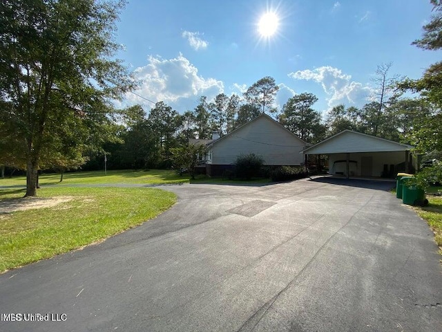 20507 Old Biloxi Rd, Vancleave, MS 39565 - view of property exterior with asphalt driveway, a yard, and a carport