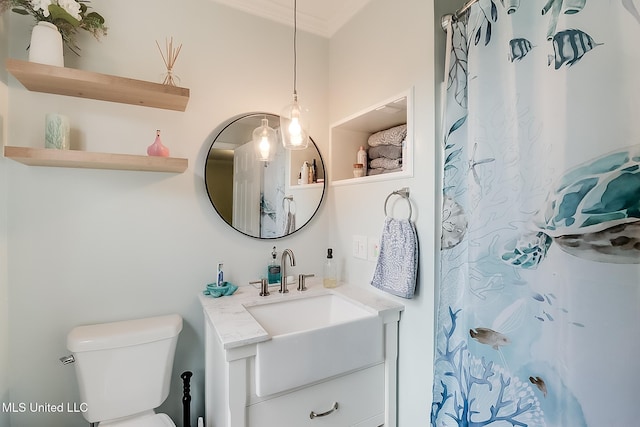 bathroom with a shower with shower curtain, vanity, toilet, and crown molding