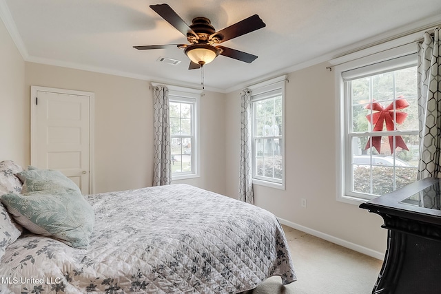 bedroom featuring multiple windows, ceiling fan, and ornamental molding