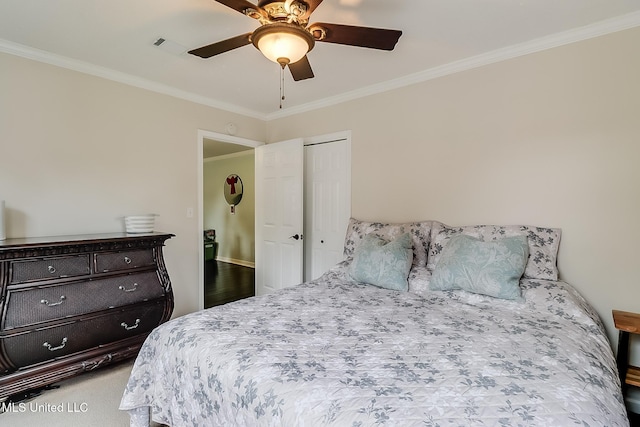 carpeted bedroom featuring ceiling fan and ornamental molding