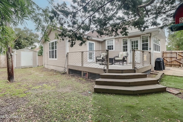 back of property featuring a storage unit and a wooden deck