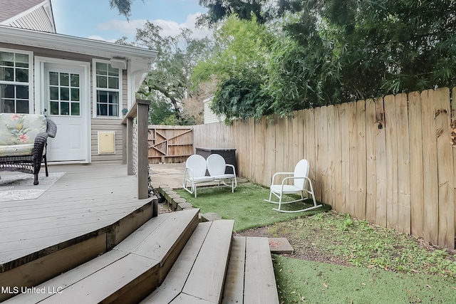 wooden terrace with a lawn