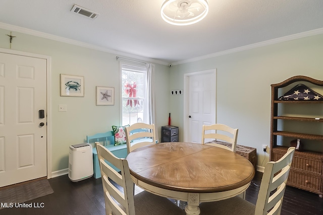 dining space featuring dark hardwood / wood-style floors and ornamental molding