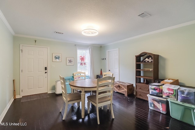 dining area featuring a textured ceiling, dark hardwood / wood-style floors, and ornamental molding