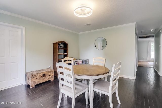 dining area featuring crown molding and dark wood-type flooring