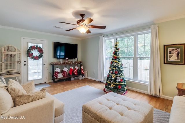 living room with ceiling fan, light hardwood / wood-style flooring, and ornamental molding