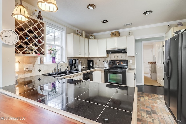 kitchen with black appliances, sink, white cabinetry, and backsplash