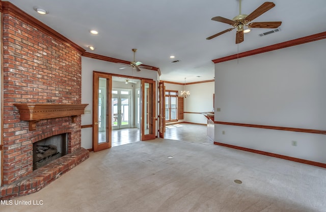 unfurnished living room featuring light carpet, french doors, crown molding, and a brick fireplace