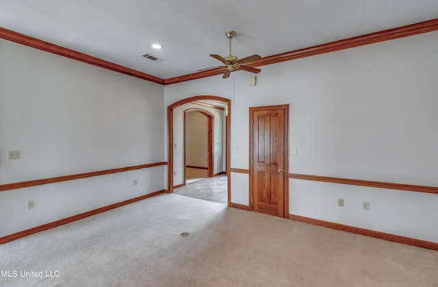 carpeted spare room featuring ornamental molding and ceiling fan