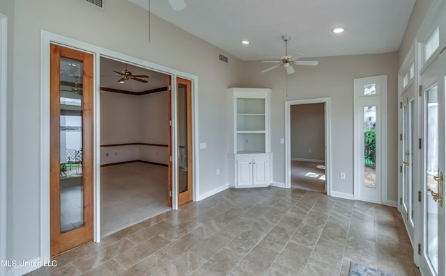 interior space with lofted ceiling and ceiling fan