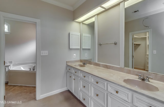 bathroom with vanity, ornamental molding, tile patterned floors, and a bathtub