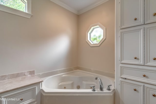 bathroom featuring a tub to relax in, ornamental molding, and plenty of natural light