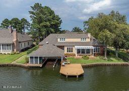 back of property featuring a water view