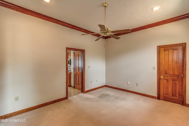 empty room with light carpet, crown molding, and ceiling fan