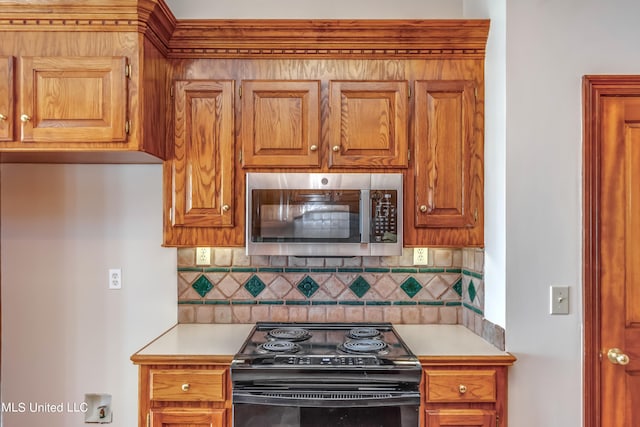 kitchen featuring backsplash and black range oven